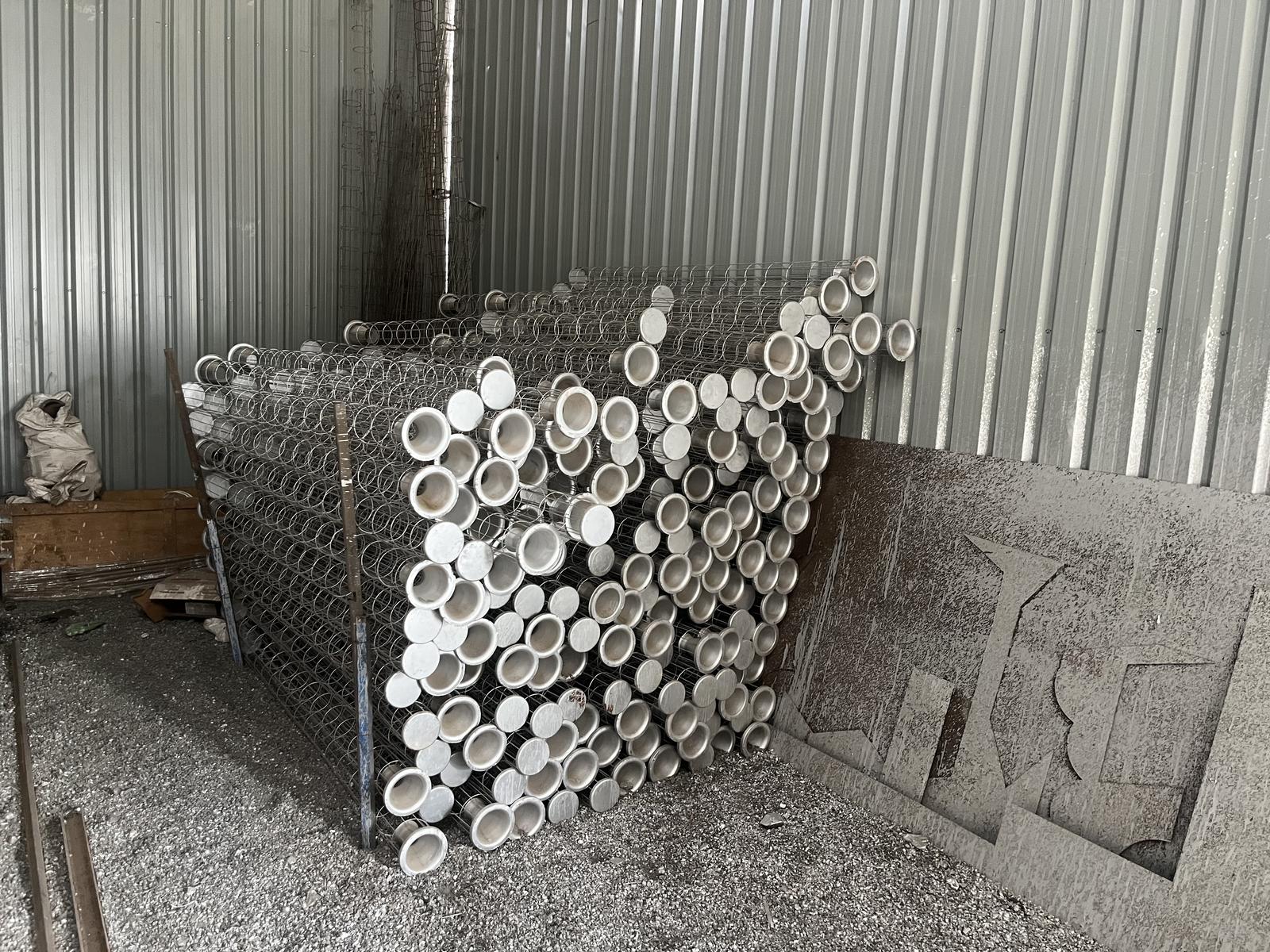 Galvanised iron filter cages manufactured by RG Steel Crafts, stacked in the yard